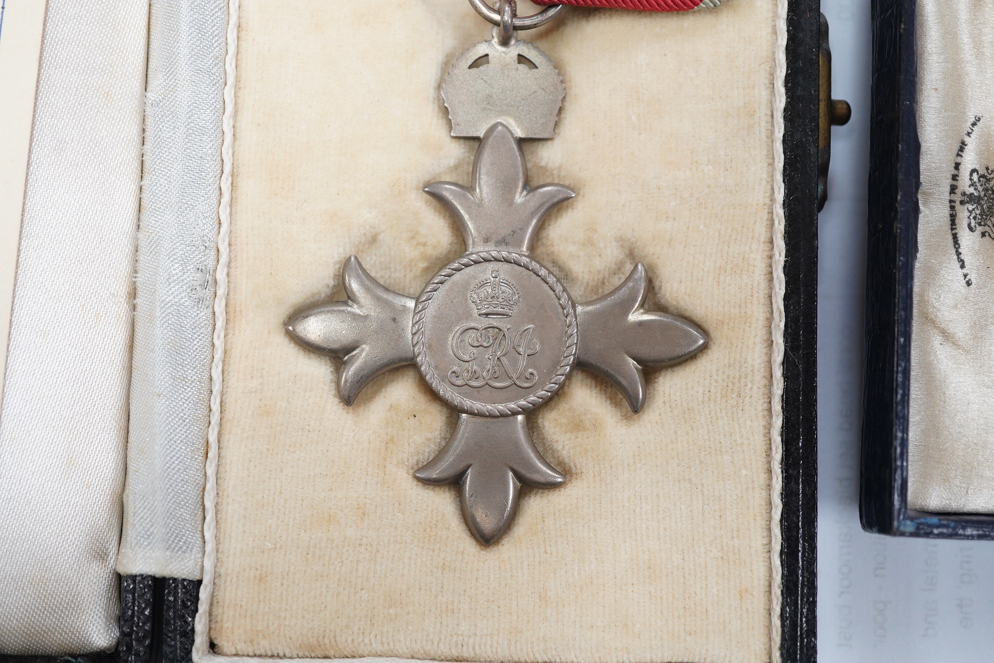 A cased George V military MBE containing leaflet with instructions as to wearing Insignia, together with the separately cased miniature. Condition - fair to good